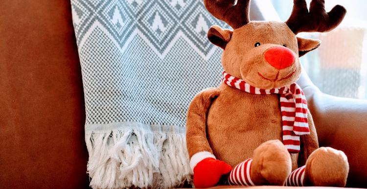 reindeer toy sat on sofa